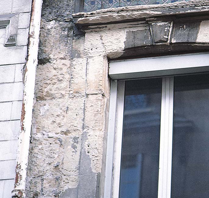 Concrete that has become brittle over time around a window still