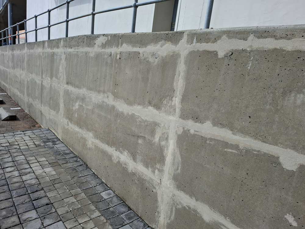 An after image of a clean concrete wall free of black efflorescence. Cleaned with Guard Wash and Eco